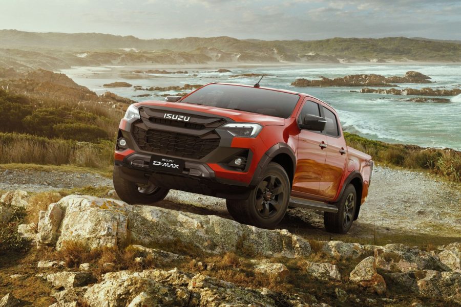 Isuzu D-Max 2026 màu cam vượt địa hình đá ven biển